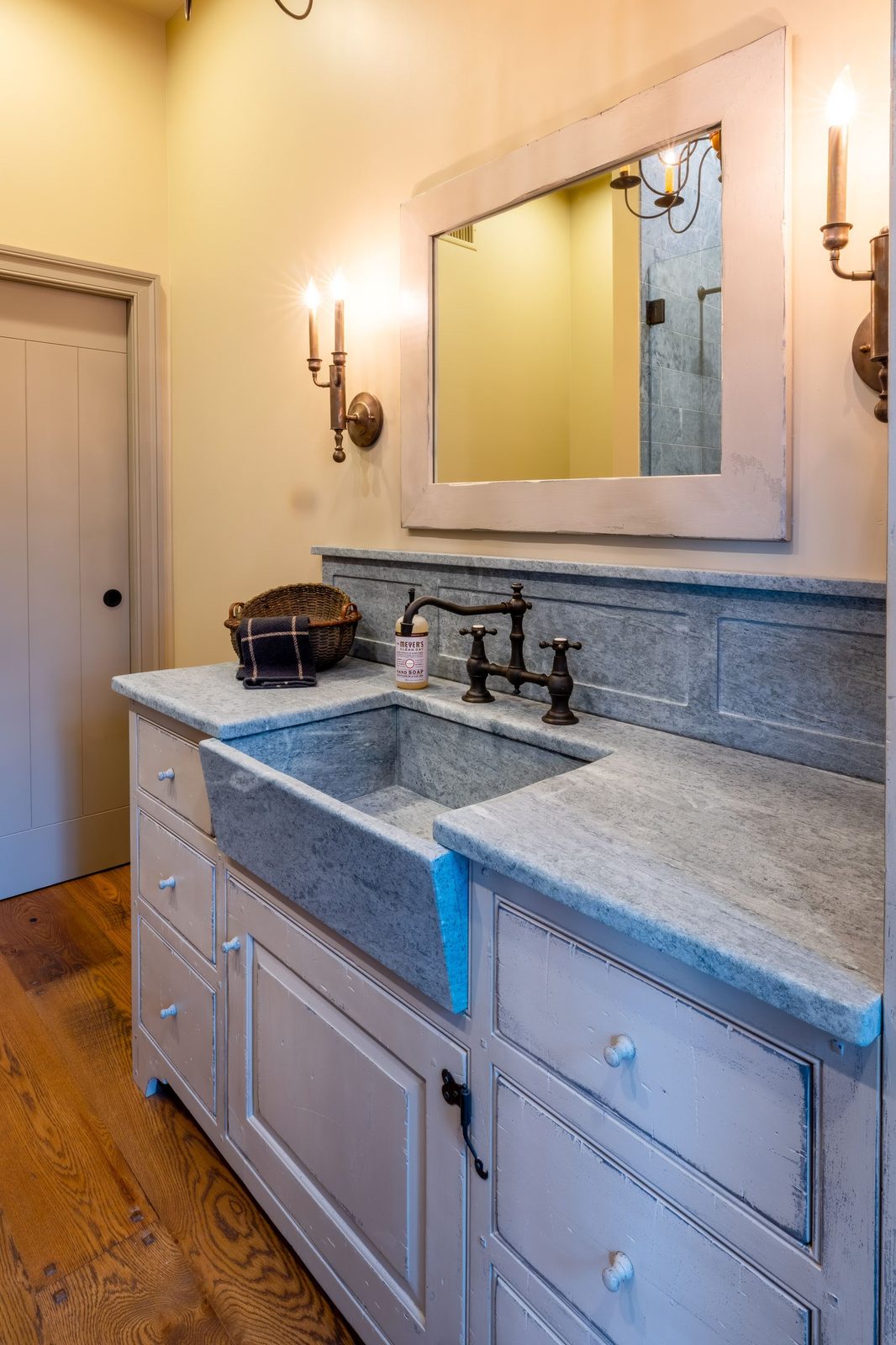 Vaulted kitchen with timber-truss ceiling and iron chandeliers