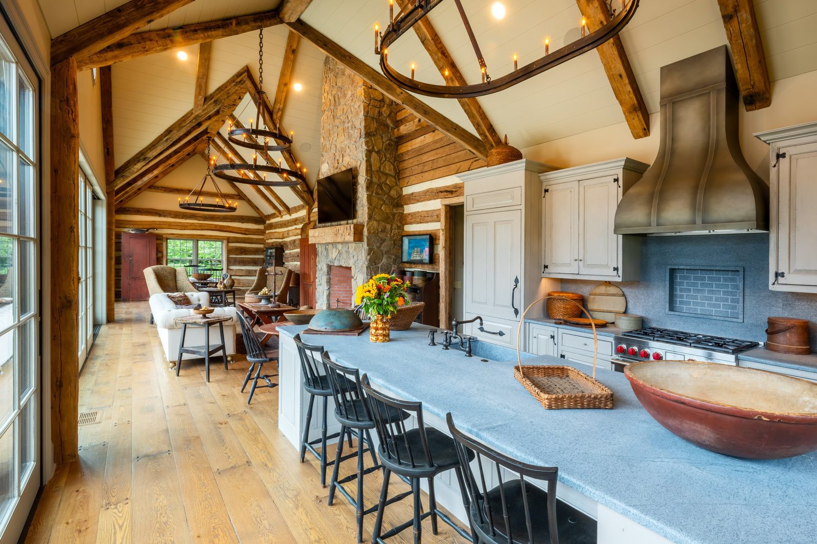 Pool house kitchen with timber framing and stone fireplace