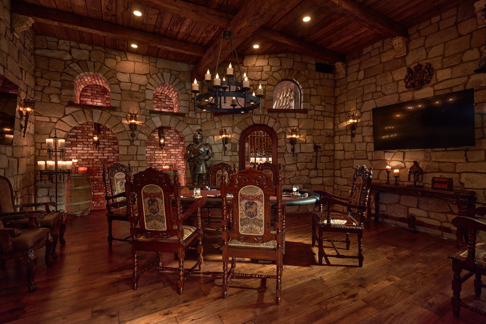 Castle Room with stone walls, throne chairs, and iron chandelier