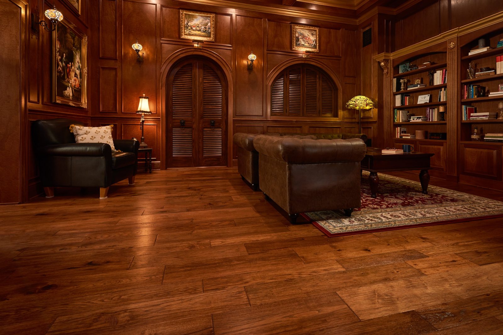 Library lounge with floor-to-ceiling wood paneling and hand-built bookcases