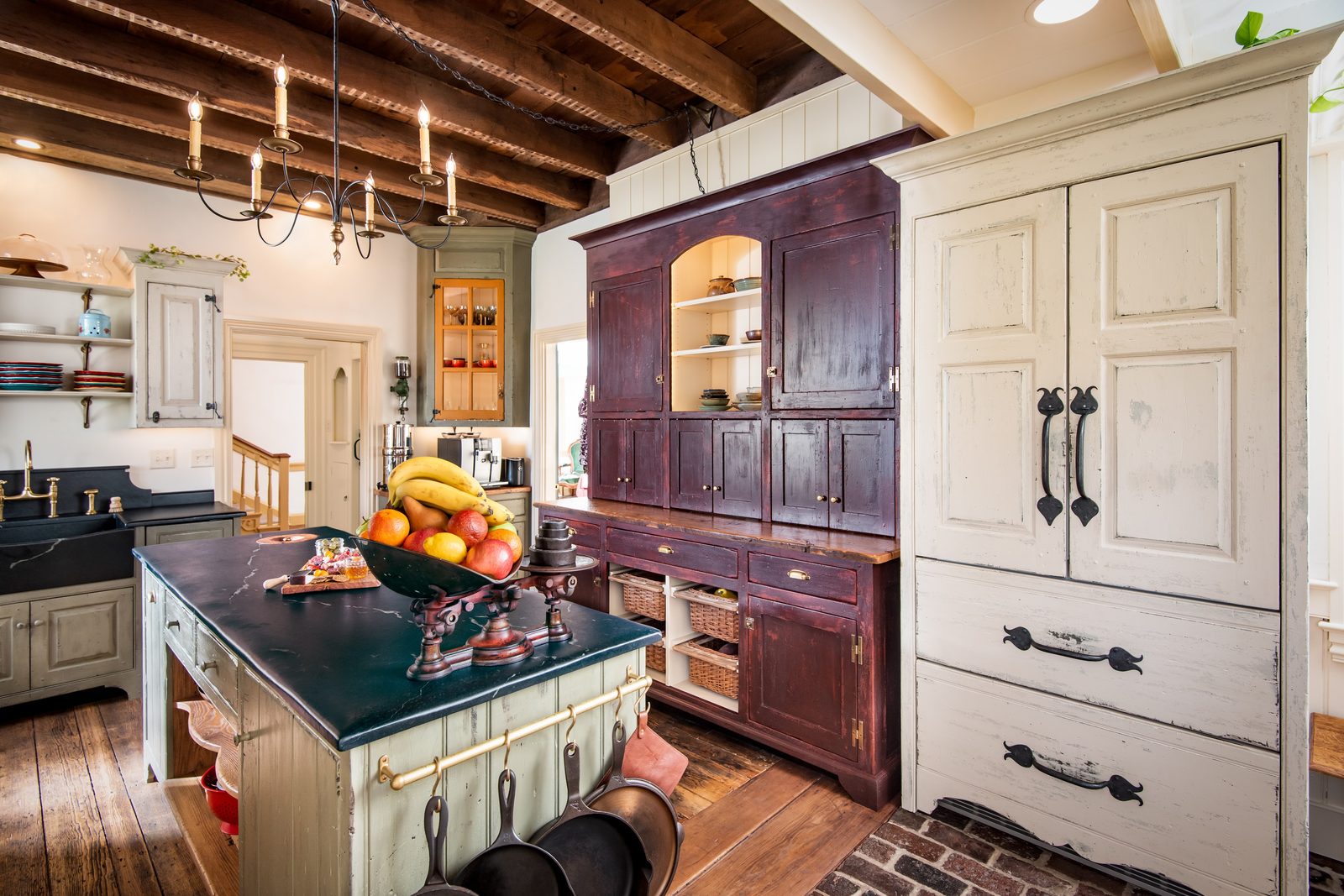 Deep-red china cabinet anchoring the kitchen wall