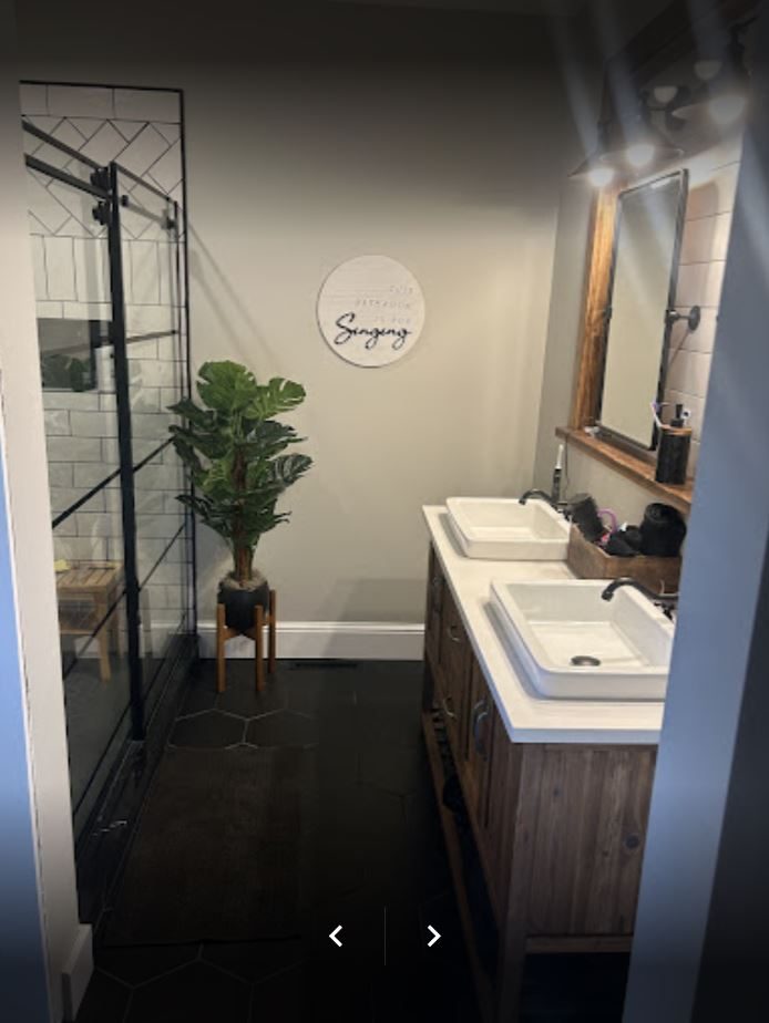 Bathroom with rustic wood vanity and subway-tile shower