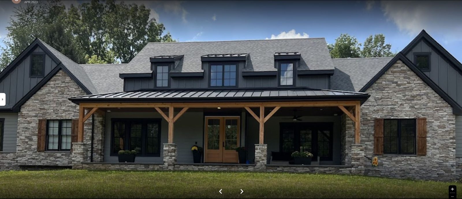 Rebuilt home with timber-frame covered porch and stone chimney