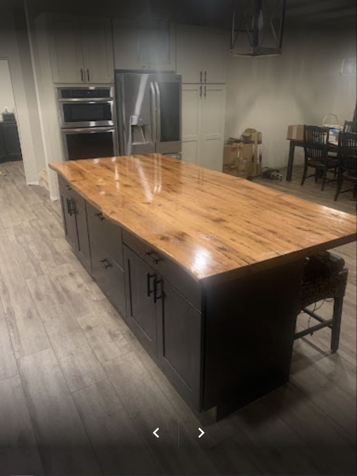 Kitchen with live-edge wood island and dark cabinets