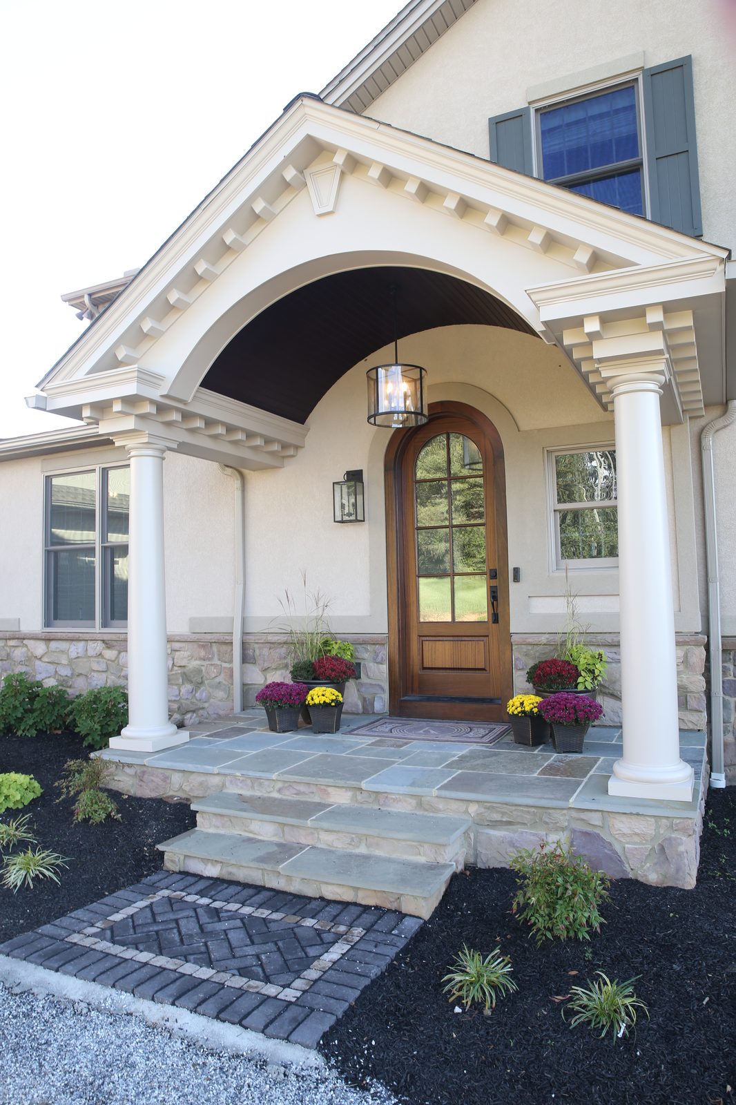 Front entry with arched portico and stone steps