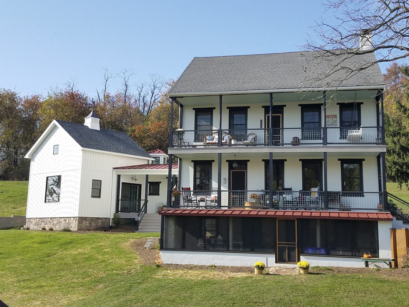 Twin-porch white farmhouse exterior
