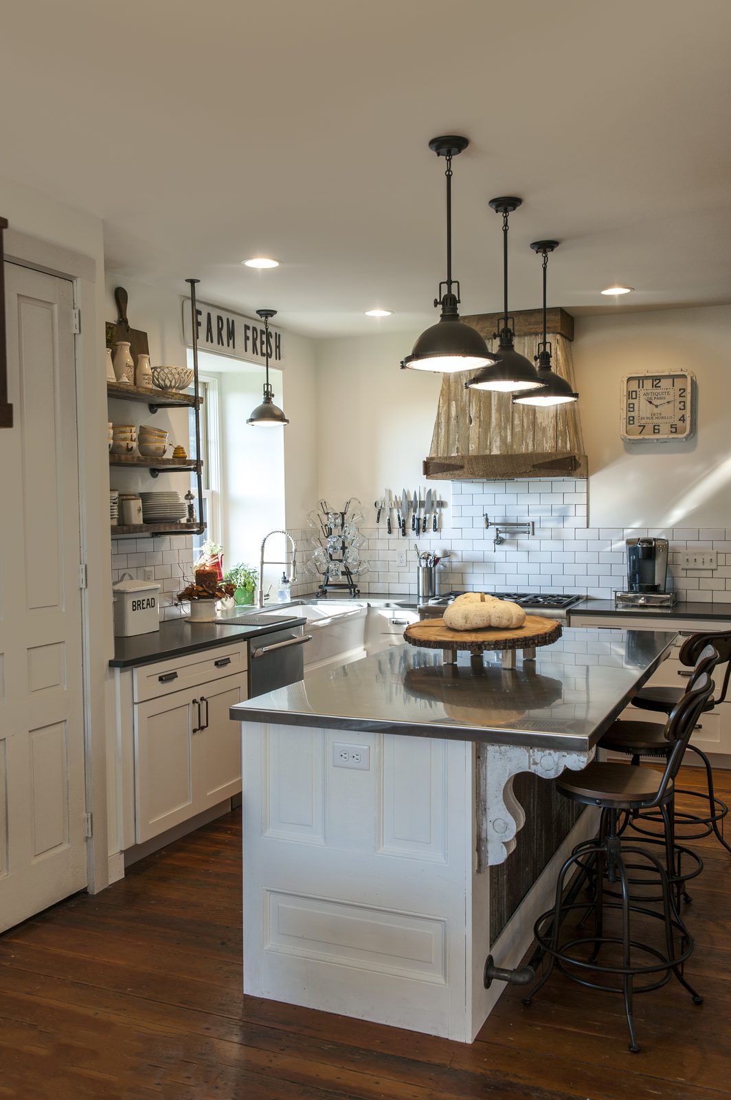 Magazine farmhouse kitchen with FARM FRESH sign and salvaged-wood range hood