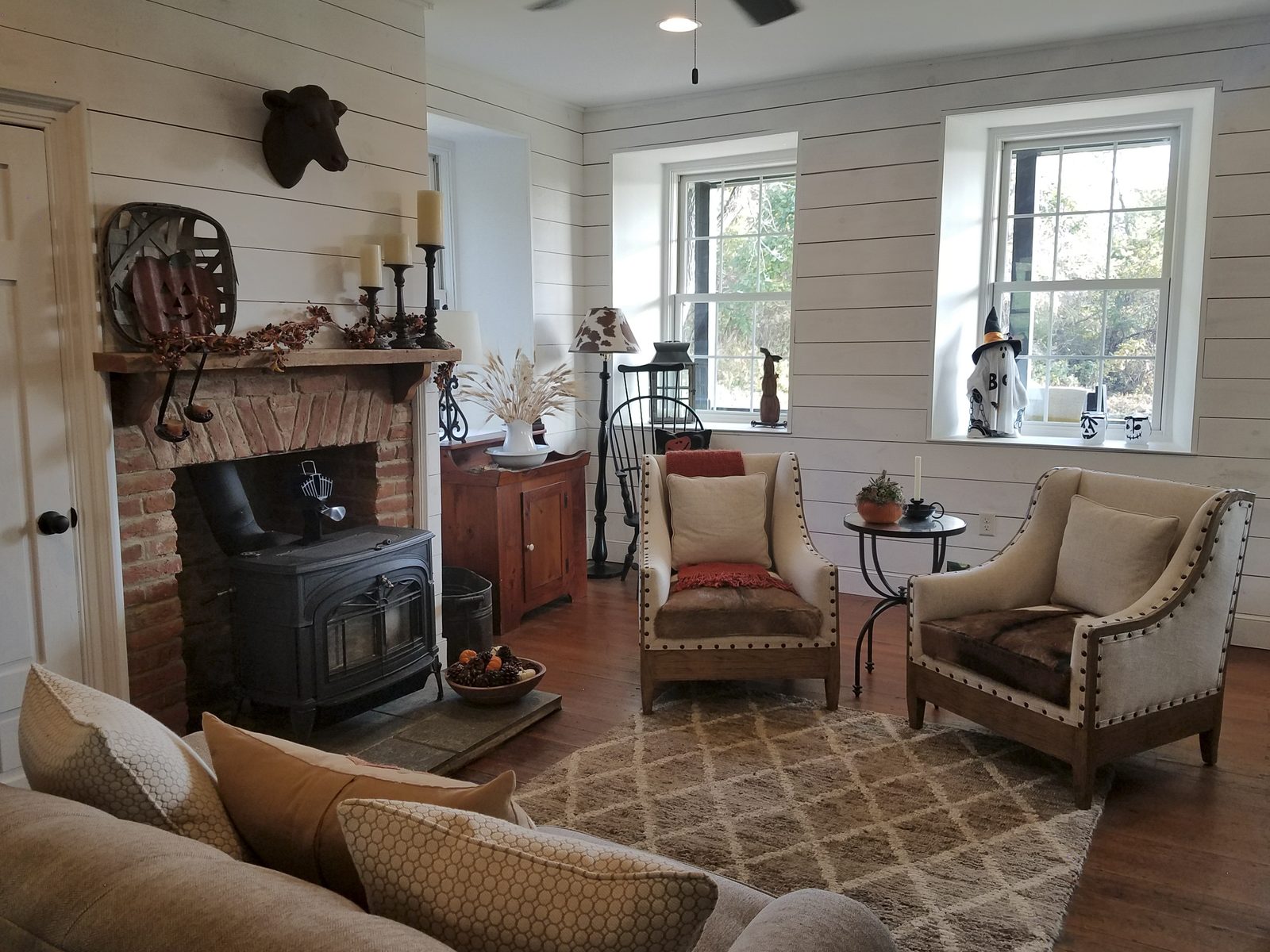 Living room with shiplap walls and brick fireplace
