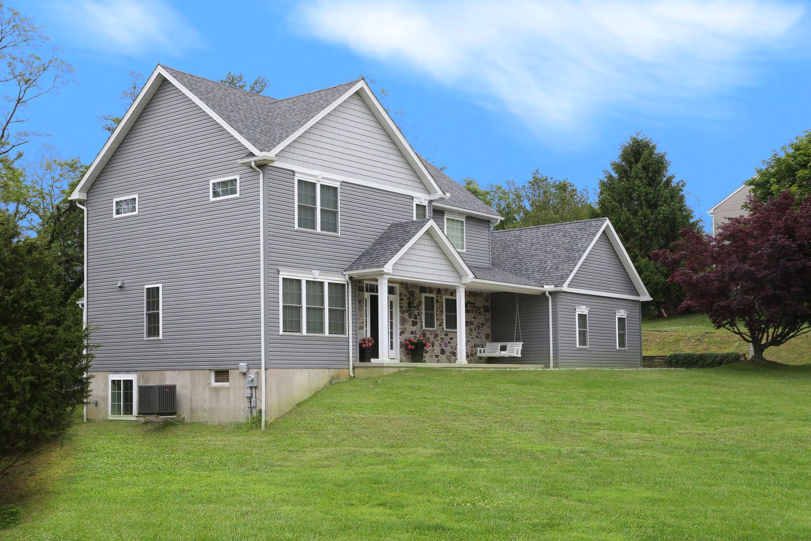 Rebuilt home exterior with expanded front porch