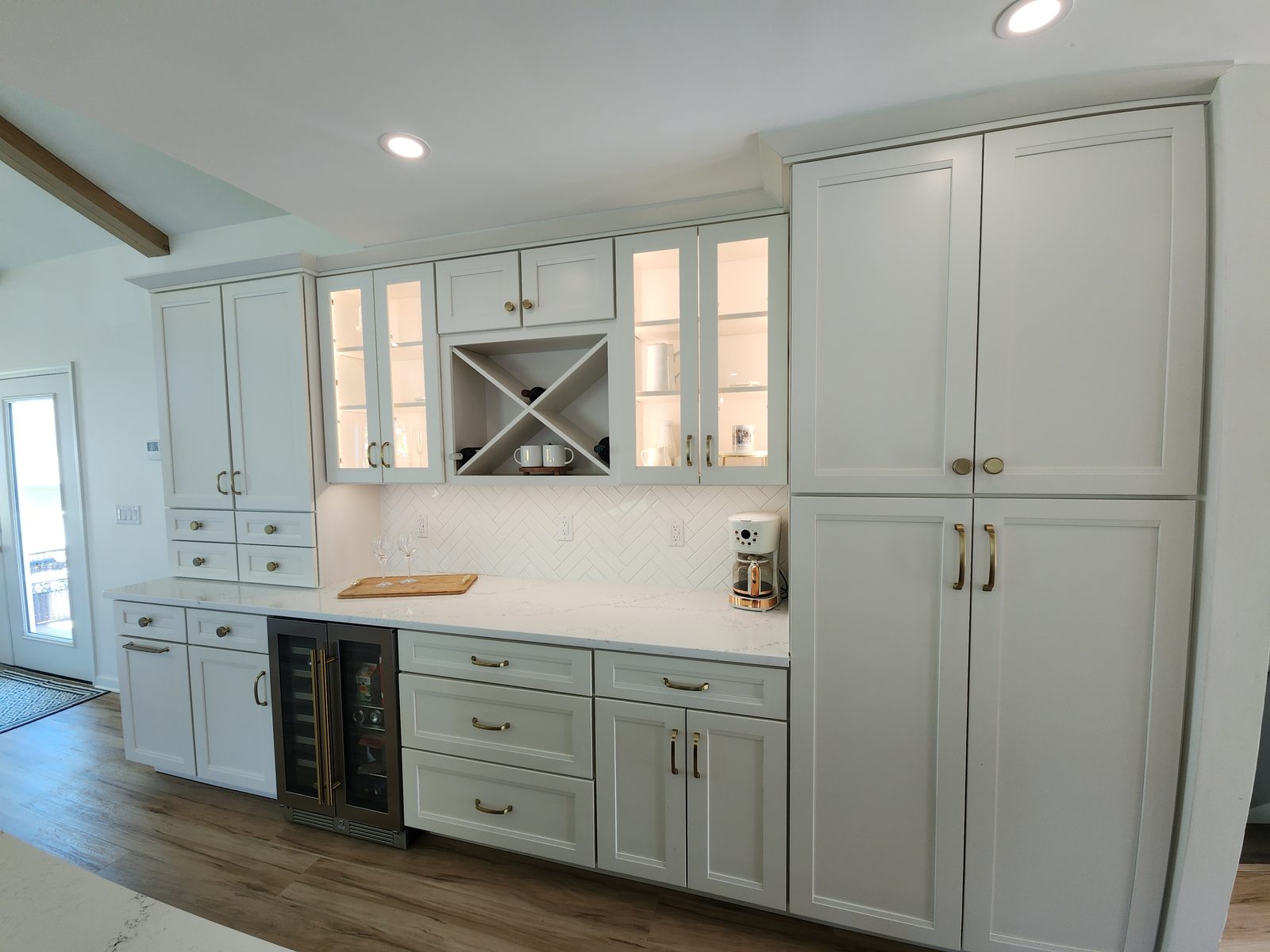Kitchen cabinetry detail with herringbone backsplash