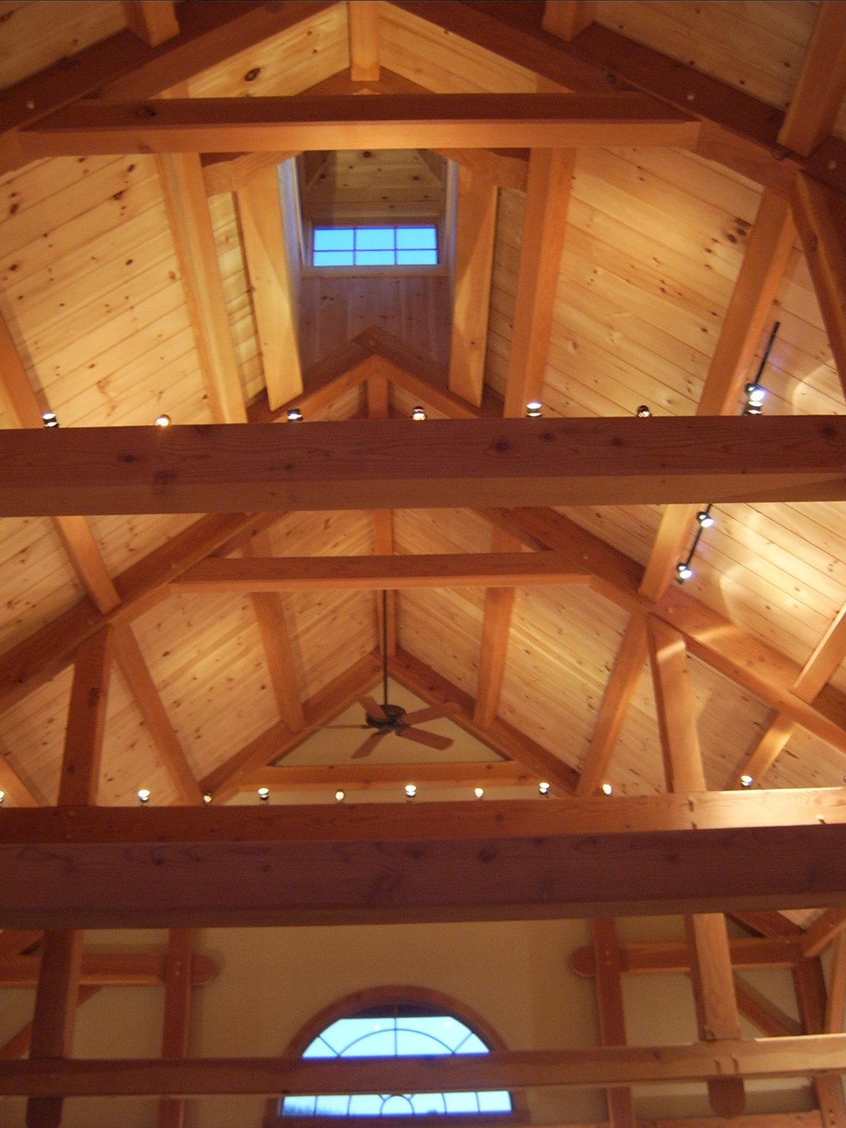 Cathedral timber-frame ceiling with multiple trusses and a cupola overhead